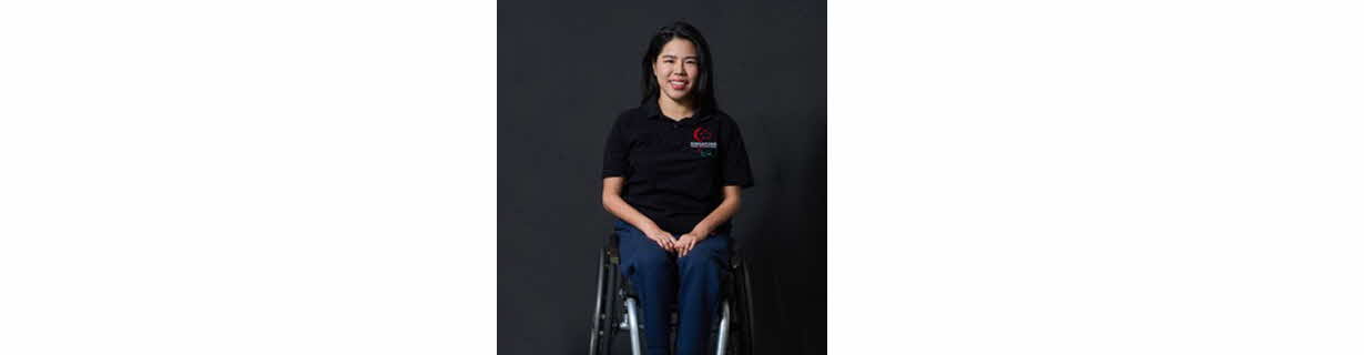 Portrait of Yip Pin Xiu, a woman in wheelchair, smiling